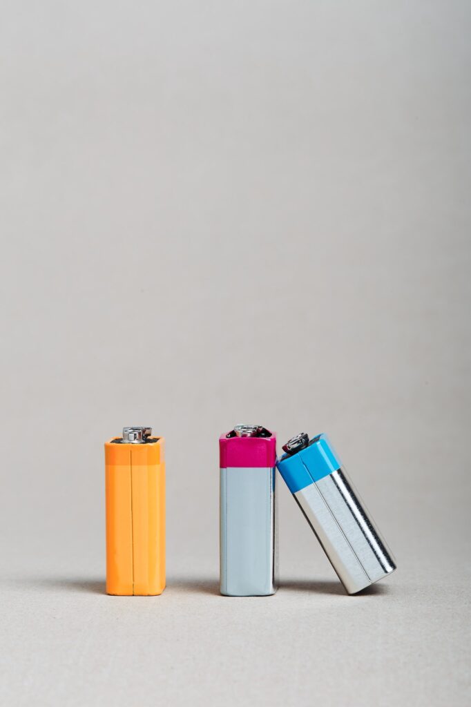 Batteries recycling. Used discharged batteries put. Battery leanted on another battery